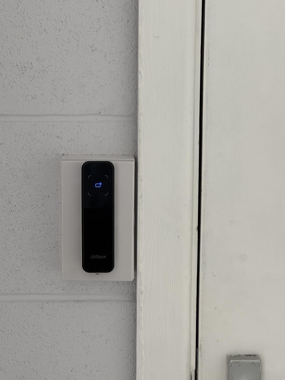 Access control fob reader beside a door