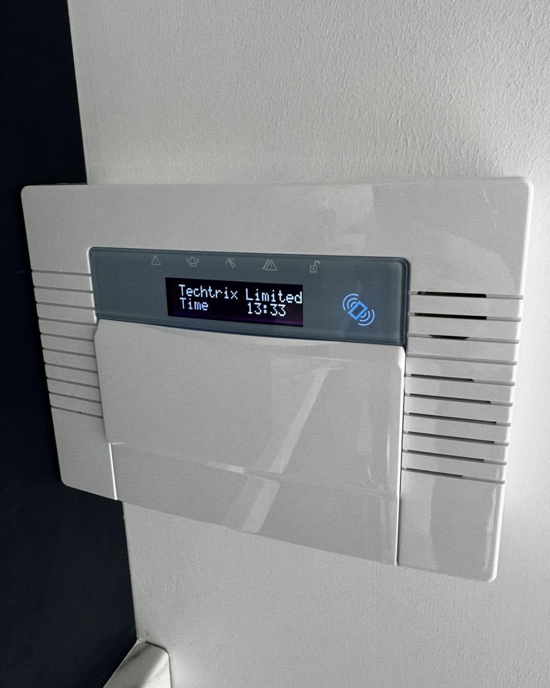 Intruder alarm keypad in a hallway