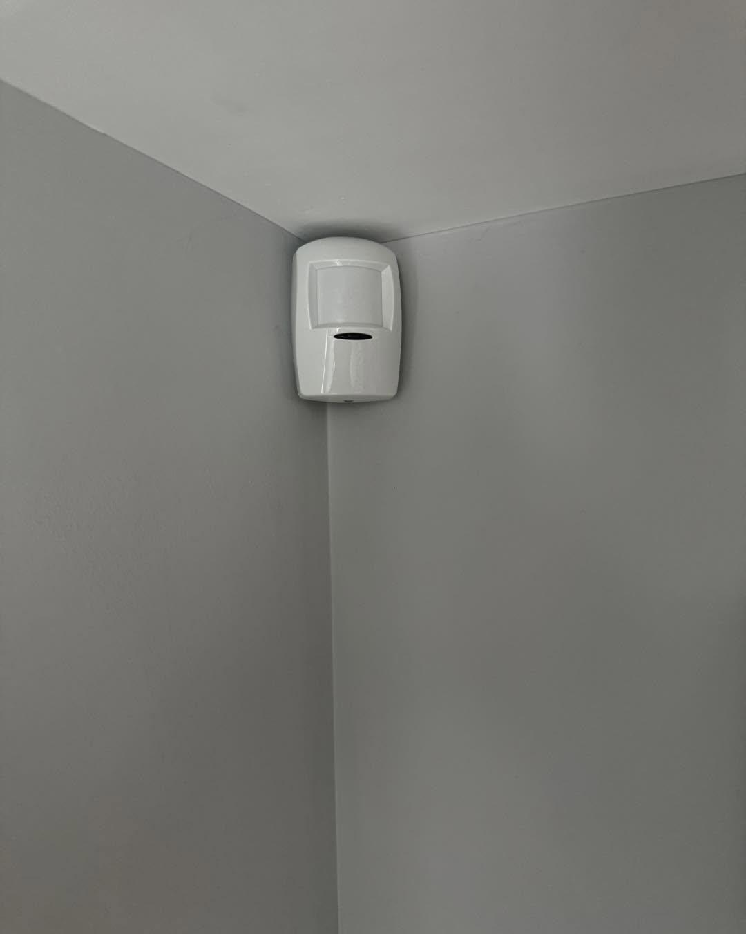 Alarm movement sensor in the corner of a room
