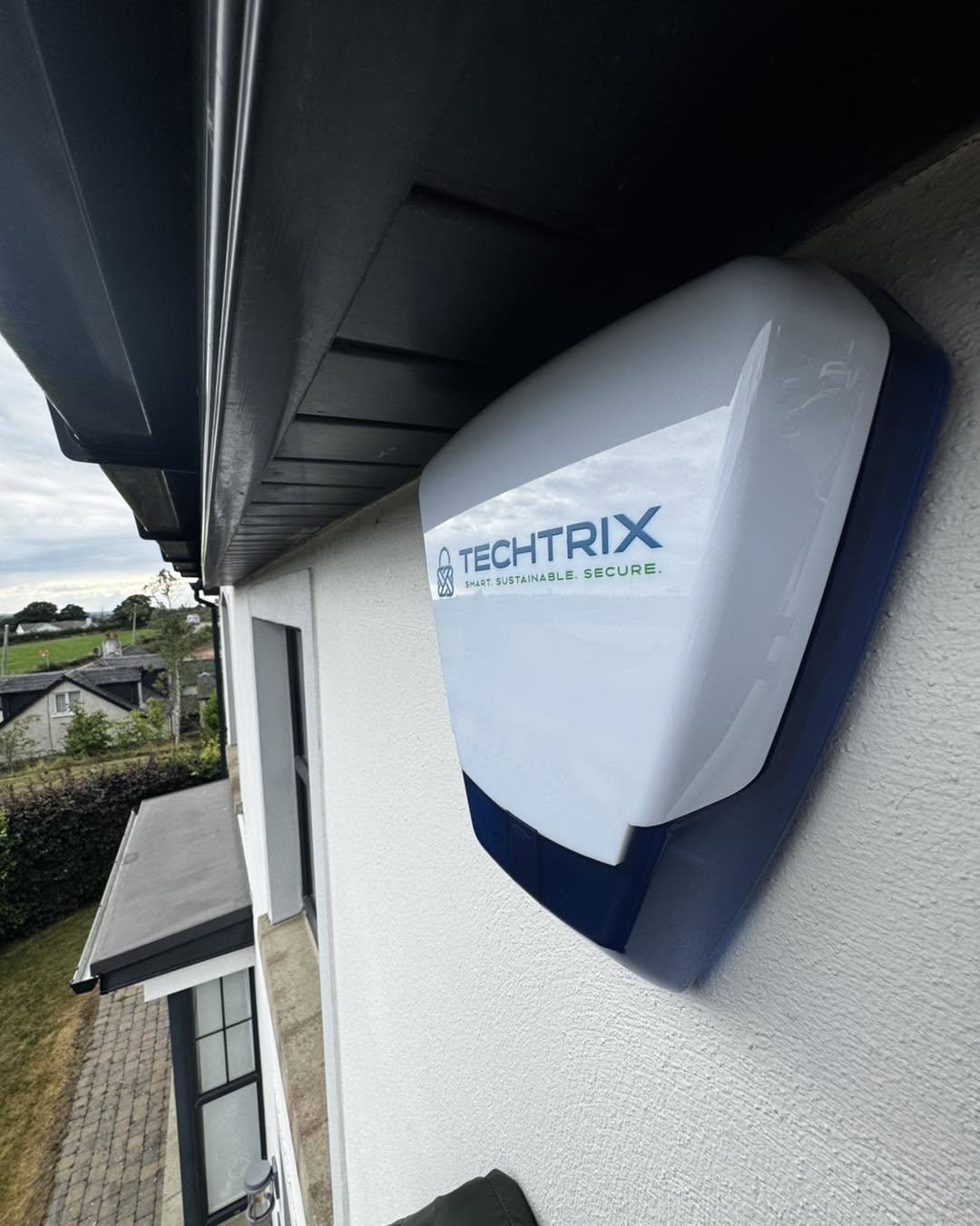 Techtrix alarm sounder under the eaves of a house