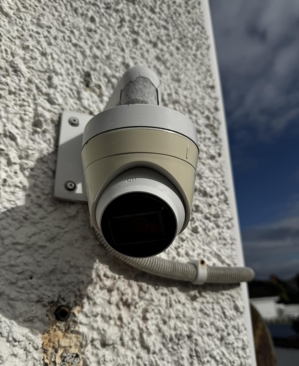 Turret camera on the outside wall of a shop