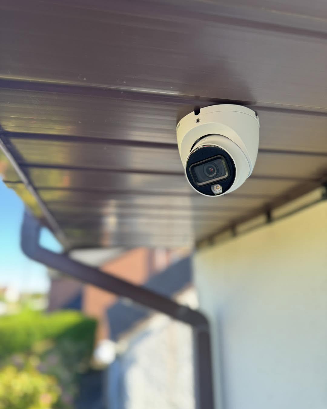 CCTV camera fitted under the eaves of a house