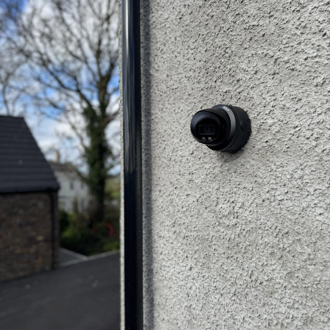 CCTV camera mounted on a rendered wall