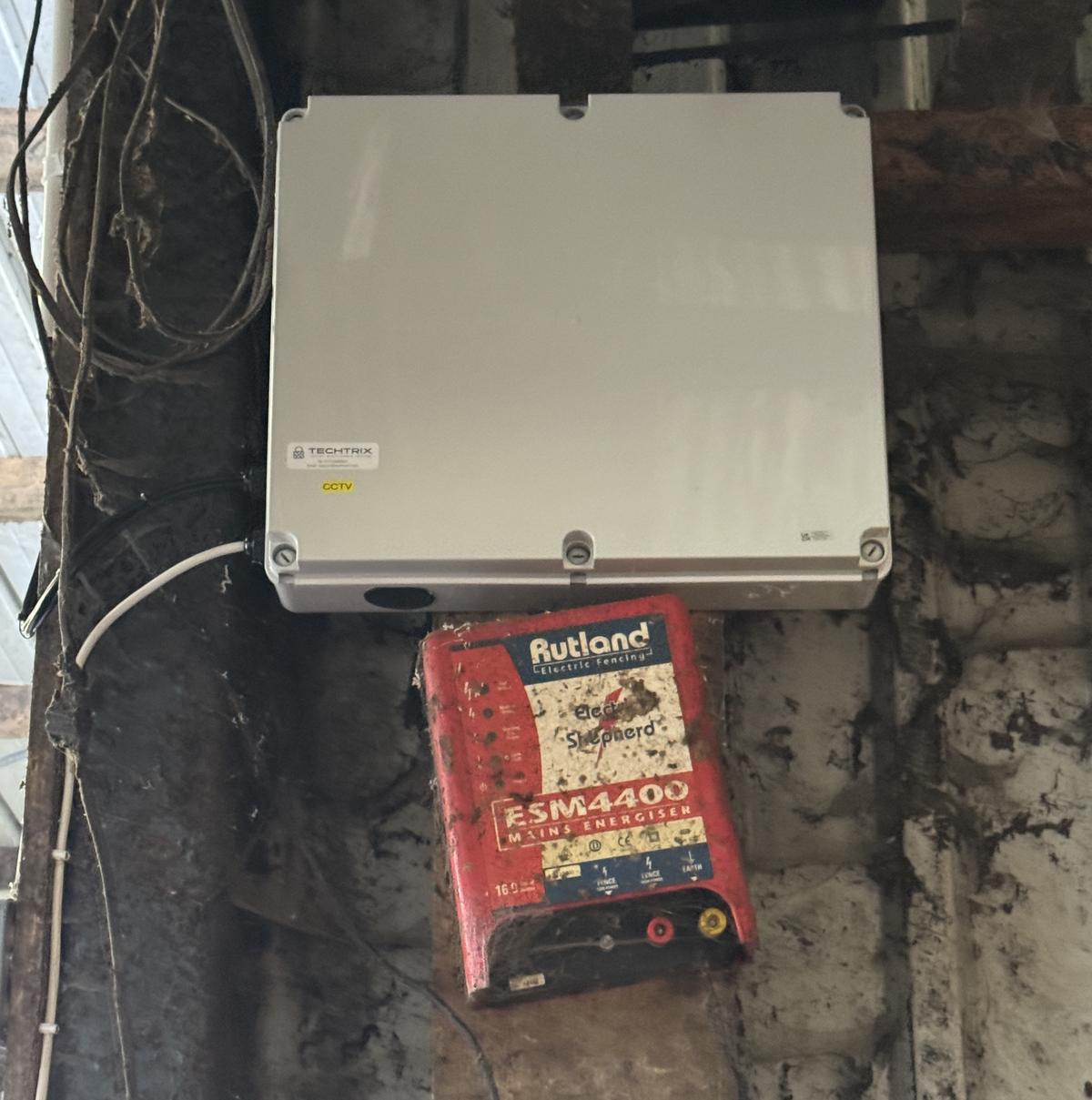 Weatherproof enclosure housing the CCTV recorder in the shed