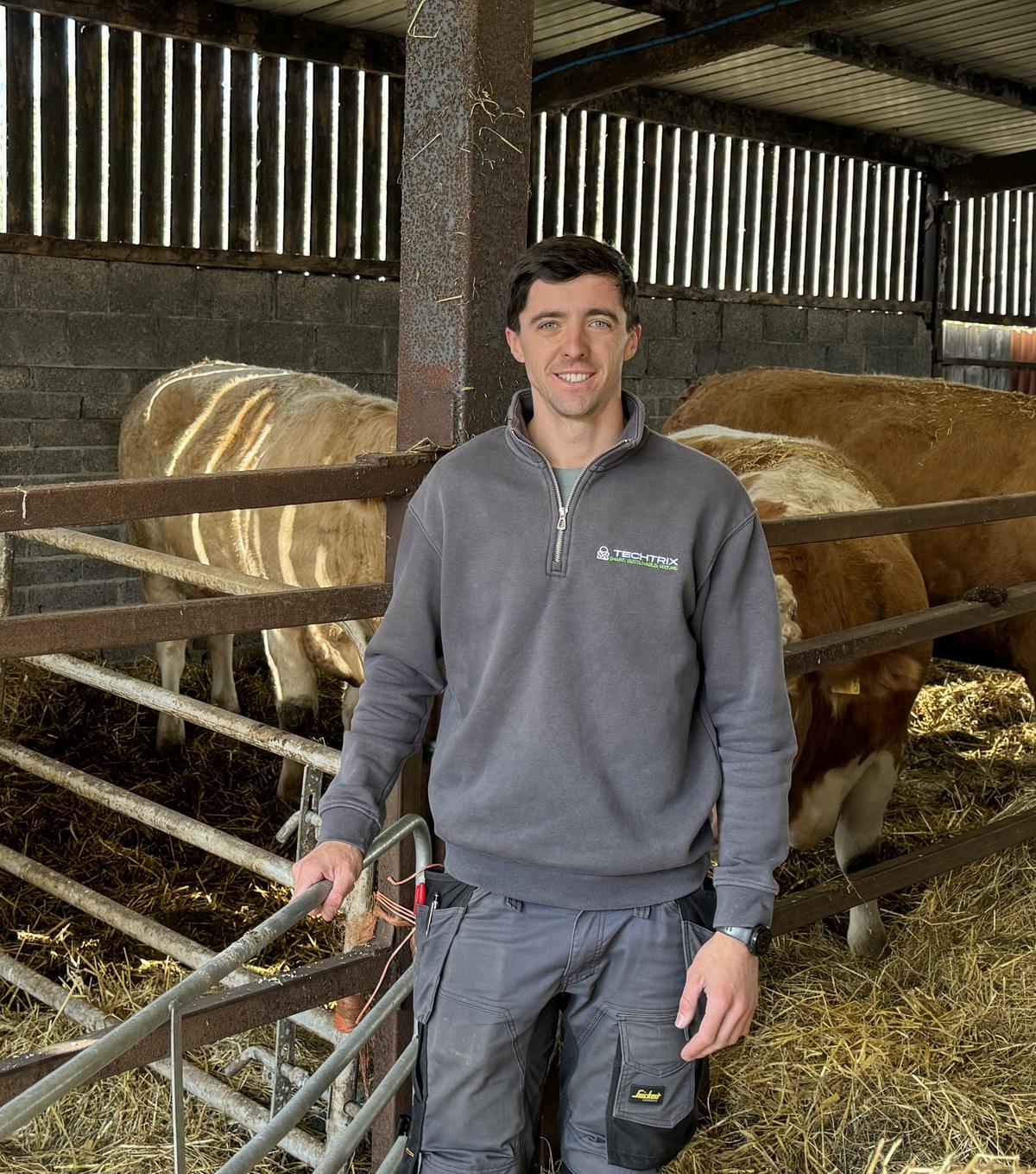 Kyle McCandless of Techtrix in a cattle shed after fitting cameras