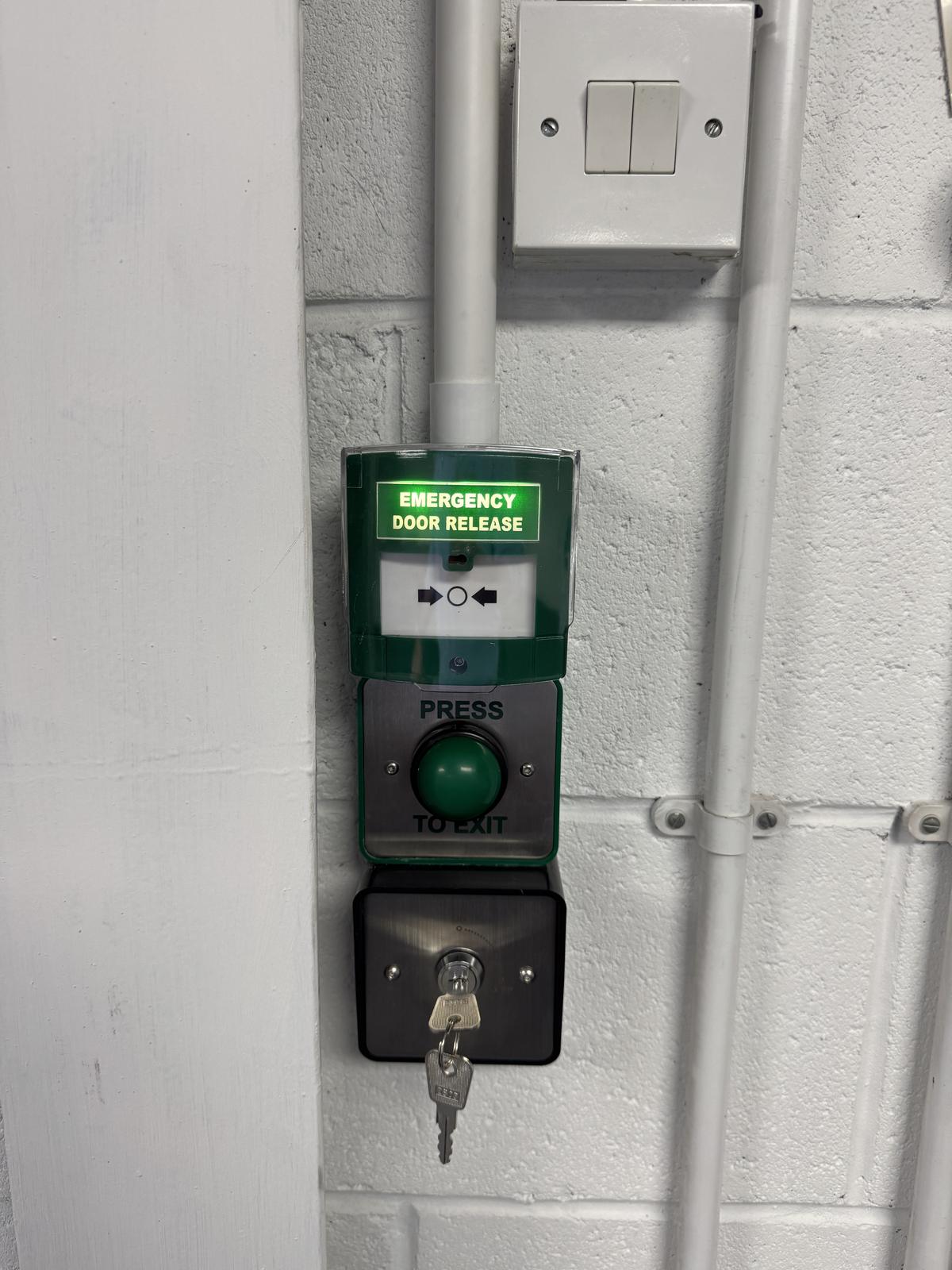 Push-to-exit button and emergency door release beside an internal door