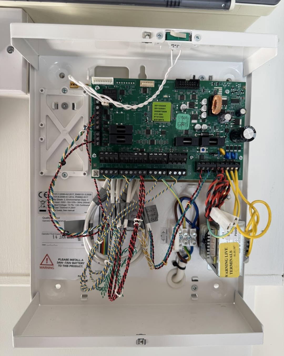 Inside a neatly wired alarm control panel