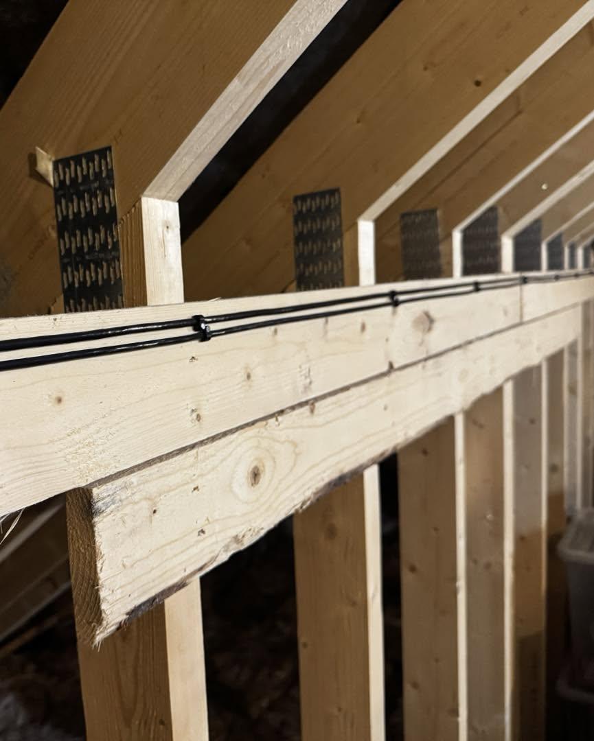 Neat cable run clipped along roof timbers