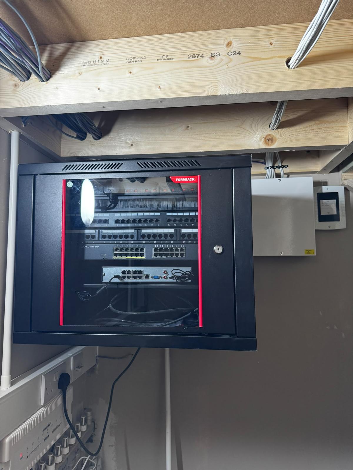 Wall-mounted comms rack installed by Techtrix